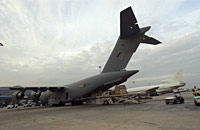 RAF personnel load humanitarian aid onto a C-17 transport aircraft at Penang airport in Malaysia. Alongside the C-17 is a Tristar from No 216 Squadron at RAF Brize Norton. 